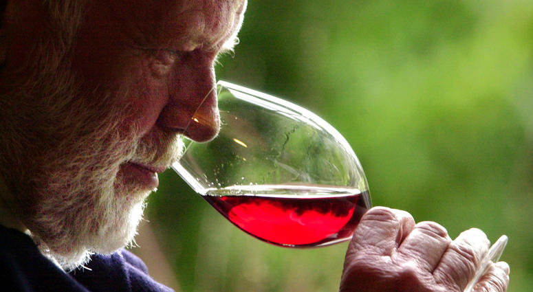 FILE--In this Feb. 23, 2004, file photo, winemaker David Lett savors the bouquet from a glass of Pinot Noir at his Eyrie Vinyards home in Dundee, Ore. FILE--In this Feb. 23, 2004, file photo, winemaker David Lett savors the bouquet from a glass of Pinot Noir at his Eyrie Vinyards home in Dundee, Ore.