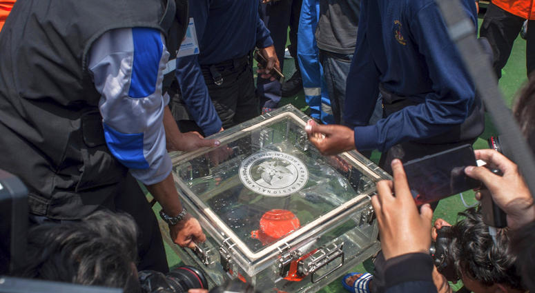 FILE - In this Thursday, Nov. 1, 2018, file photo, members of the National Transportation Safety Committee lift a box containing the flight data recorder from a crashed Lion Air jet onboard a rescue ship anchored in the waters of Tanjung Karawang, Indones FILE - In this Thursday, Nov. 1, 2018, file photo, members of the National Transportation Safety Committee lift a box containing the flight data recorder from a crashed Lion Air jet onboard a rescue ship anchored in the waters of Tanjung Karawang, Indones
