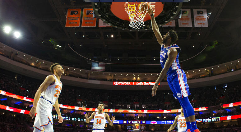 Philadelphia 76ers' Joel Embiid, right, of Cameroon, dunks the ball as New York Knicks' Kevin Knox, left, looks on during the first half of an NBA basketball game, Wednesday, Nov. 28, 2018, in Philadelphia. Philadelphia 76ers' Joel Embiid, right, of Cameroon, dunks the ball as New York Knicks' Kevin Knox, left, looks on during the first half of an NBA basketball game, Wednesday, Nov. 28, 2018, in Philadelphia.