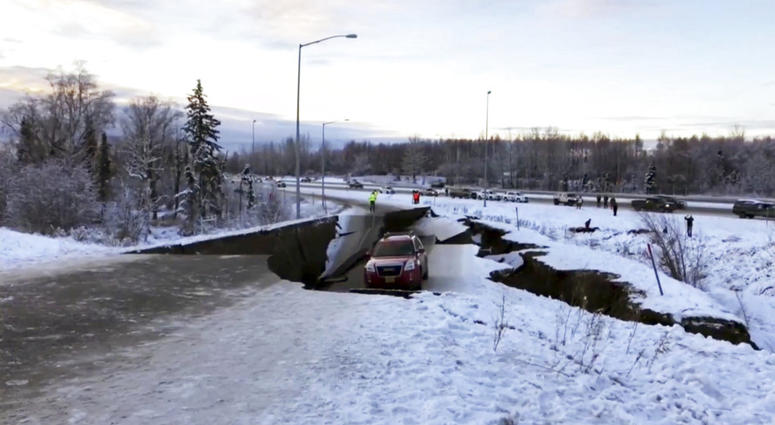 A car is trapped on a collapsed section of the offramp in Anchorage, Friday, Nov. 30, 2018. Alaska Earthquake