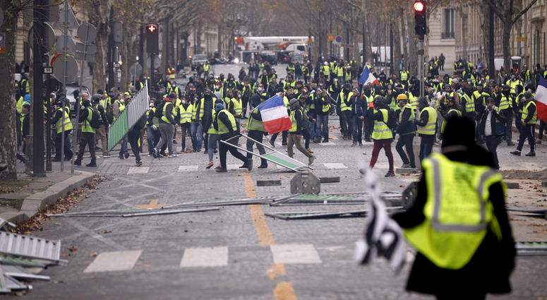 Demonstrators build a barricade near the Champs-Elysees avenue during a demonstration Saturday, Dec. 1, 2018 in Paris.