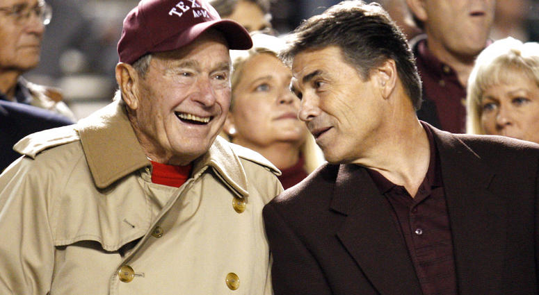 FILE - In this Nov. 26, 2009, file photo, former President George H.W. Bush, left, talks with Texas Gov. Rick Perry before an NCAA college football game between Texas and Texas A&M, in College Station, Texas. FILE - In this Nov. 26, 2009, file photo, former President George H.W. Bush, left, talks with Texas Gov. Rick Perry before an NCAA college football game between Texas and Texas A&M, in College Station, Texas.