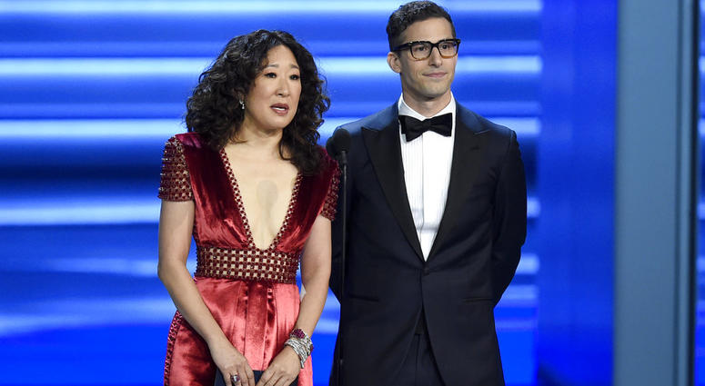 FILE - In this Sept. 17, 2018 file photo, Sandra Oh, left, and Andy Samberg present an award at the 70th Primetime Emmy Awards in Los Angeles. FILE - In this Sept. 17, 2018 file photo, Sandra Oh, left, and Andy Samberg present an award at the 70th Primetime Emmy Awards in Los Angeles.