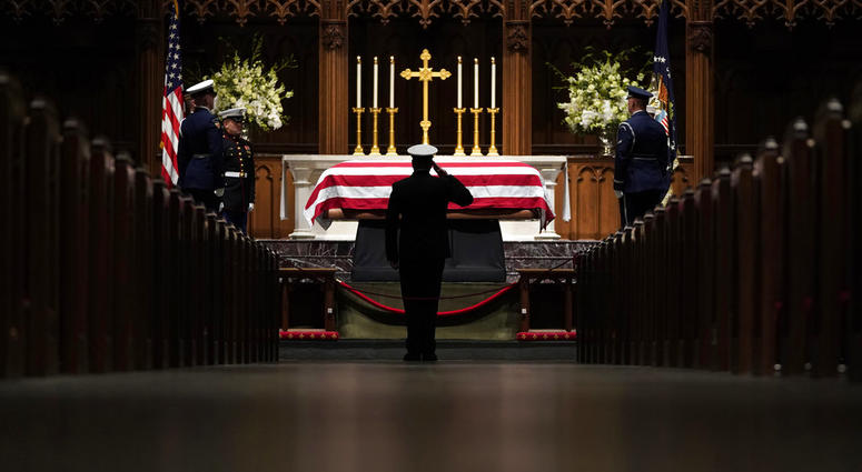 People pay their respects as the flag-draped casket of former President George H.W. Bush lies in repose at St. Martin's Episcopal Church Wednesday, Dec. 5, 2018, in Houston. People pay their respects as the flag-draped casket of former President George H.W. Bush lies in repose at St. Martin's Episcopal Church Wednesday, Dec. 5, 2018, in Houston.