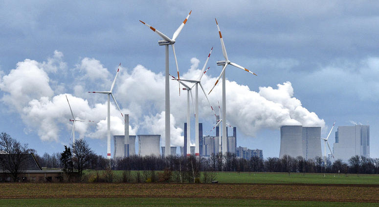 Renewable and fossil-fuel energy is produced when wind generators are seen in front of a coal fired power plant near Jackerath, Germany, Friday, Dec. 7, 2018. Renewable and fossil-fuel energy is produced when wind generators are seen in front of a coal fired power plant near Jackerath, Germany, Friday, Dec. 7, 2018.