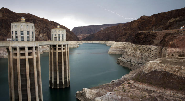 FILE - In this July 28, 2014, file photo, lightning strikes over Lake Mead near Hoover Dam that impounds Colorado River water at the Lake Mead National Recreation Area in Arizona. FILE - In this July 28, 2014, file photo, lightning strikes over Lake Mead near Hoover Dam that impounds Colorado River water at the Lake Mead National Recreation Area in Arizona.