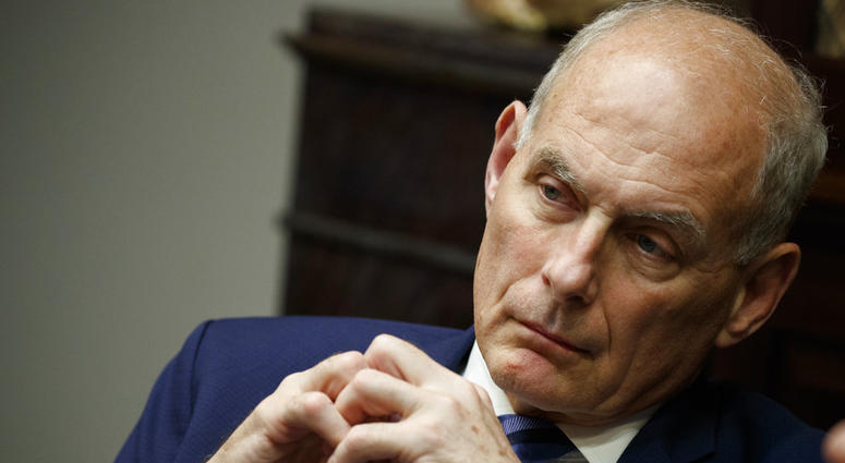In this June 21, 2018 photo, White House chief of staff John Kelly listens as President Donald Trump speaks during a lunch with governors in the Roosevelt Room of the White House in Washington. John Kelly