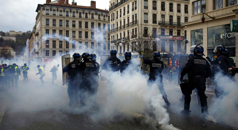 Police officers clash with demonstrators in Lyon, central France, Saturday, Dec. 8, 2018. Police officers clash with demonstrators in Lyon, central France, Saturday, Dec. 8, 2018.