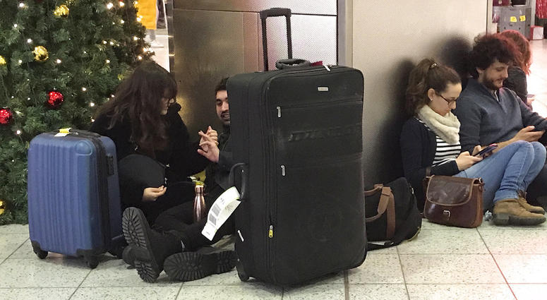 Passengers wait at Gatwick Airport in England, Friday, Dec. 21, 2018. Passengers wait at Gatwick Airport in England, Friday, Dec. 21, 2018.