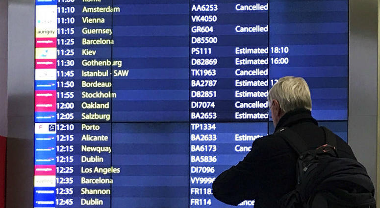 A passenger checks an arrivals board at Gatwick Airport in England, Friday, Dec. 21, 2018. A passenger checks an arrivals board at Gatwick Airport in England, Friday, Dec. 21, 2018.