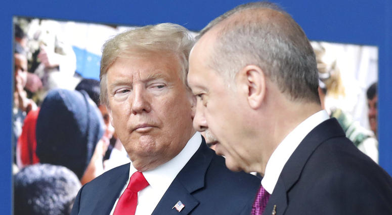In this July 11, 2018 file photo, President Donald Trump, left, talks to Turkish President Recep Tayyip Erdogan as they tour the new NATO headquarters in Brussels, Belgium. President Donald Trump talks to Turkish President Recep Tayyip Erdogan.