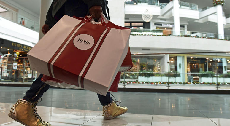 In this Dec. 22, 2017, file photo, people shop at the Pentagon City Mall in Arlington, Va. In this Dec. 22, 2017, file photo, people shop at the Pentagon City Mall in Arlington, Va.