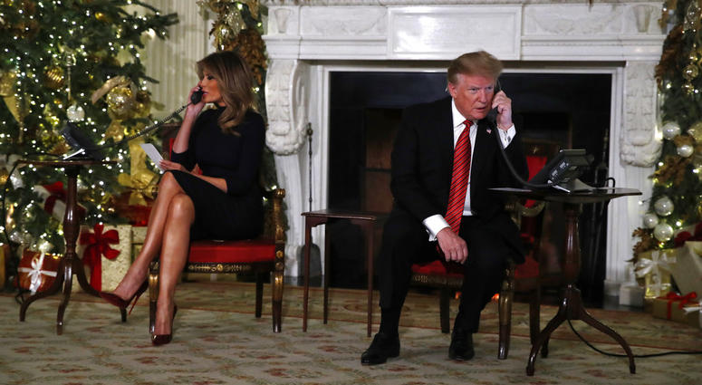 President Donald Trump and first lady Melania Trump each speak on the phone sharing updates to track Santa's movements from the North American Aerospace Defense Command (NORAD) Santa Tracker on Christmas Eve, Monday, Dec. 24, 2018. President Donald Trump and first lady Melania Trump
