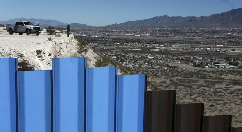 In this Jan. 25, 2017, file photo, an agent from the border patrol, observes near the Mexico-US border fence, on the Mexican side, separating the towns of Anapra, Mexico and Sunland Park, N.M. In this Jan. 25, 2017, file photo, an agent from the border patrol, observes near the Mexico-US border fence, on the Mexican side, separating the towns of Anapra, Mexico and Sunland Park, N.M.