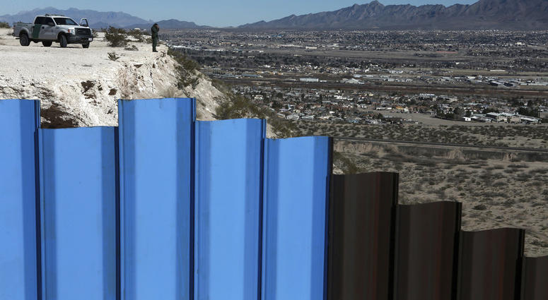 FILE - In this Jan. 25, 2017, file photo, an agent from the border patrol, observes near the Mexico-US border fence, on the Mexican side, separating the towns of Anapra, Mexico and Sunland Park, N.M. FILE - In this Jan. 25, 2017, file photo, an agent from the border patrol, observes near the Mexico-US border fence, on the Mexican side, separating the towns of Anapra, Mexico and Sunland Park, N.M.