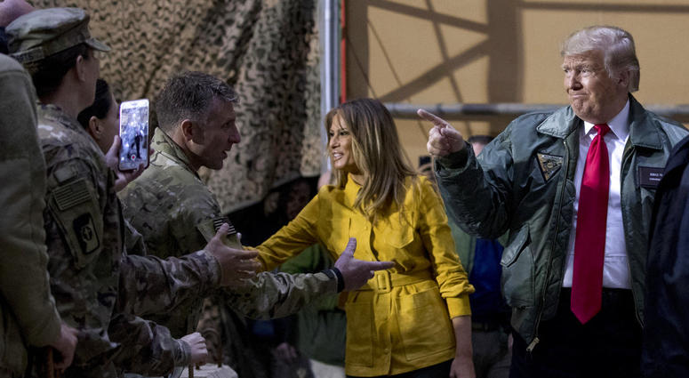 President Donald Trump and first lady Melania Trump greet members of the military as they arrive for a hangar rally at Al Asad Air Base, Iraq, Wednesday, Dec. 26, 2018. President Donald Trump and first lady Melania Trump greet members of the military as they arrive for a hangar rally at Al Asad Air Base, Iraq, Wednesday, Dec. 26, 2018.