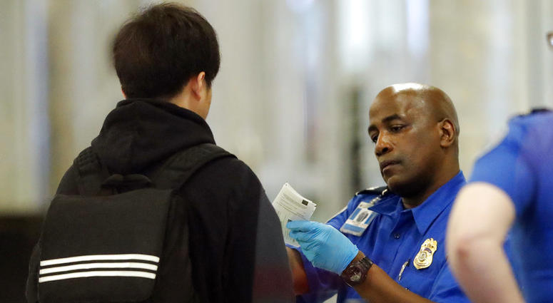 A Transportation Security Administration employee checks an air traveler's identification at Hartsfield Jackson Atlanta International Airport Monday, Jan. 7, 2019, in Atlanta. A Transportation Security Administration employee checks an air traveler's identification at Hartsfield Jackson Atlanta International Airport Monday, Jan. 7, 2019, in Atlanta.