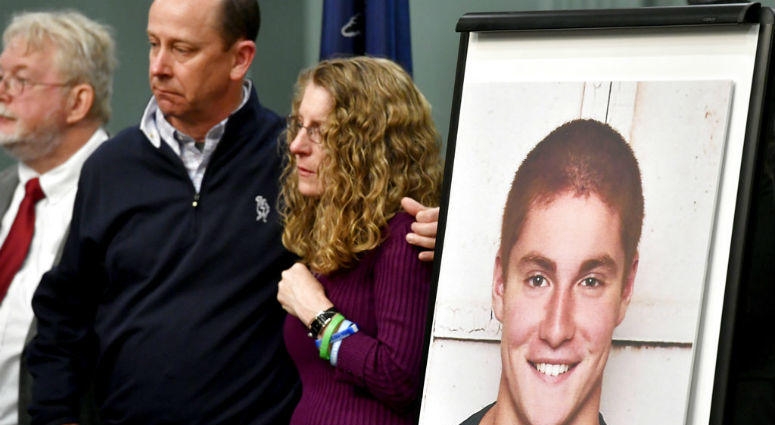 FILE - In this May 5, 2017, file photo, Jim and Evelyn Piazza stand by as Centre County District Attorney Stacy Parks Miller announces the results of an investigation into the death of their son Timothy Piazza, seen in photo at right, a Penn State Univers FILE - In this May 5, 2017, file photo, Jim and Evelyn Piazza stand by as Centre County District Attorney Stacy Parks Miller announces the results of an investigation into the death of their son Timothy Piazza, seen in photo at right, a Penn State Univers