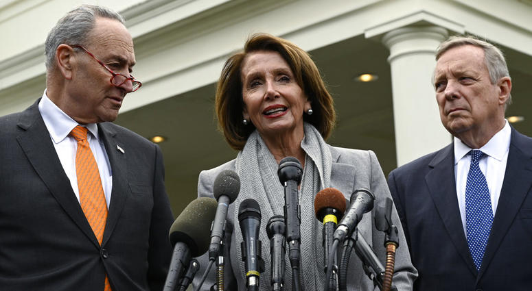 House Speaker Nancy Pelosi of Calif., center, standing with Senate Minority Leader Sen. Chuck Schumer of N.Y., left, and Sen. Dick Durbin, D-Ill., right, speak with reporters following their meeting with President Donald Trump at the White House. Nancy Pelosi, center, standing with Chuck Schumer, left, and Dick Durbin