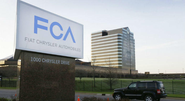 FILE - In this May 6, 2014, file photo, a vehicle moves past a sign outside Fiat Chrysler Automobiles world headquarters in Auburn Hills, Mich. FILE - In this May 6, 2014, file photo, a vehicle moves past a sign outside Fiat Chrysler Automobiles world headquarters in Auburn Hills, Mich.