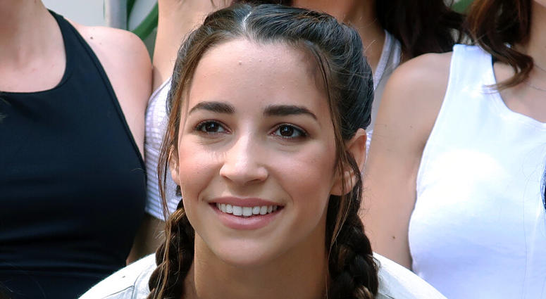 Olympic gymnast Aly Raisman poses with other yoga enthusiasts on International Yoga Day in Times Square in New York, June 21, 2018. Olympic gymnast Aly Raisman