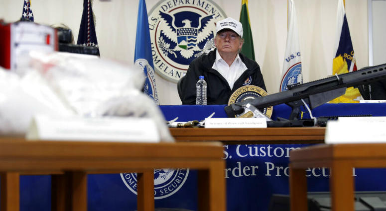 With illegal drugs and weapons displayed in the foreground, President Donald Trump speaks at a roundtable on immigration and border security at U.S. Border Patrol McAllen Station, during a visit to the southern border, Thursday, Jan. 10, 2019, in McAllen, With illegal drugs and weapons displayed in the foreground, President Donald Trump speaks at a roundtable on immigration and border security at U.S. Border Patrol McAllen Station, during a visit to the southern border, Thursday, Jan. 10, 2019, in McAllen,