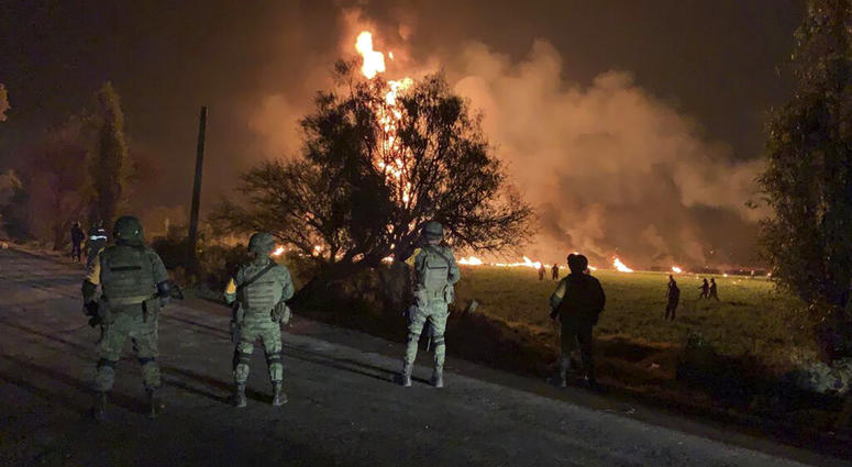 In this image provided by the Secretary of National Defense, soldiers guard the area by an oil pipeline explosion in Tlahuelilpan, Hidalgo state, Mexico, Friday, Jan. 18, 2019. mexico explosion
