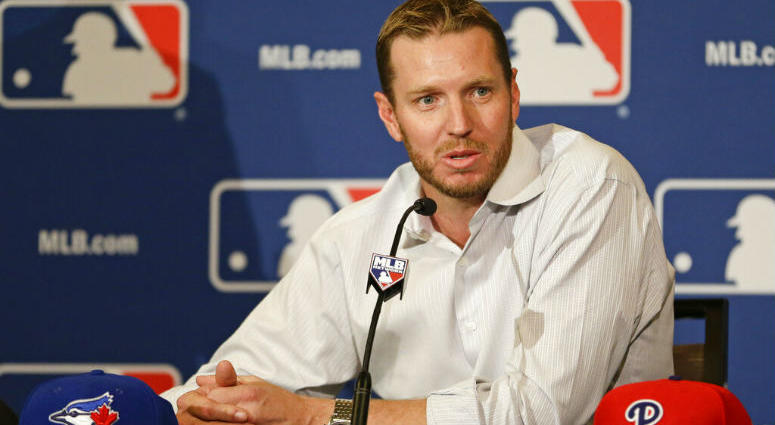 FILE - In this Dec. 9, 2013, file photo, two-time Cy Young Award winner Roy Halladay answers questions after announcing his retirement after 16 seasons in the major leagues with Toronto and Philadelphia at the MLB winter meetings in Lake Buena Vista, Fla. FILE - In this Dec. 9, 2013, file photo, two-time Cy Young Award winner Roy Halladay answers questions after announcing his retirement after 16 seasons in the major leagues with Toronto and Philadelphia at the MLB winter meetings in Lake Buena Vista, Fla.