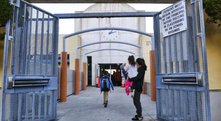 Parents and toddler wave to children as they return to the Evelyn Thurman Gratts Elementary School in downtown Los Angeles, Wednesday, Jan. 23, 2019, following a city wide teachers' strike. Parents and toddler wave to children as they return to the Evelyn Thurman Gratts Elementary School in downtown Los Angeles, Wednesday, Jan. 23, 2019, following a city wide teachers' strike.