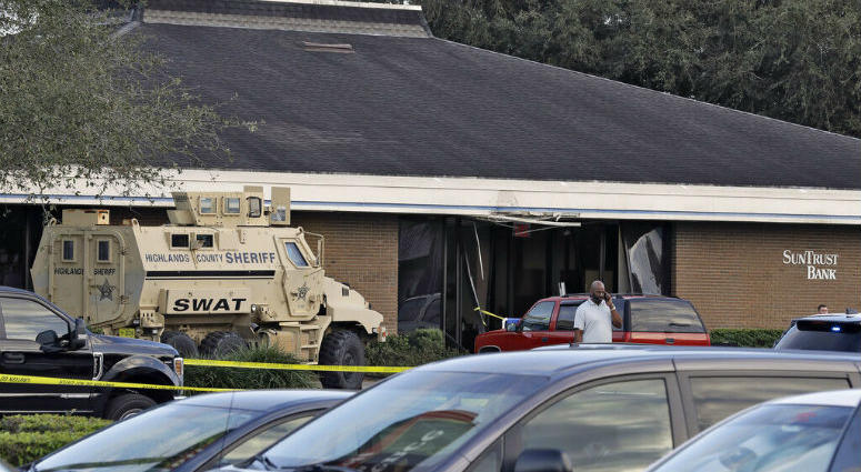 A Highlands County Sheriff's SWAT vehicle is stationed out in front of a SunTrust Bank branch, Wednesday, Jan. 23, 2019, in Sebring, Fla., where authorities say five people were shot and killed. A Highlands County Sheriff's SWAT vehicle is stationed out in front of a SunTrust Bank branch, Wednesday, Jan. 23, 2019, in Sebring, Fla., where authorities say five people were shot and killed.