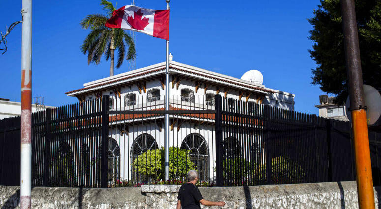 FILE - In this April 17, 2018 file photo, a man walks beside Canada's embassy in Havana, Cuba. FILE - In this April 17, 2018 file photo, a man walks beside Canada's embassy in Havana, Cuba.