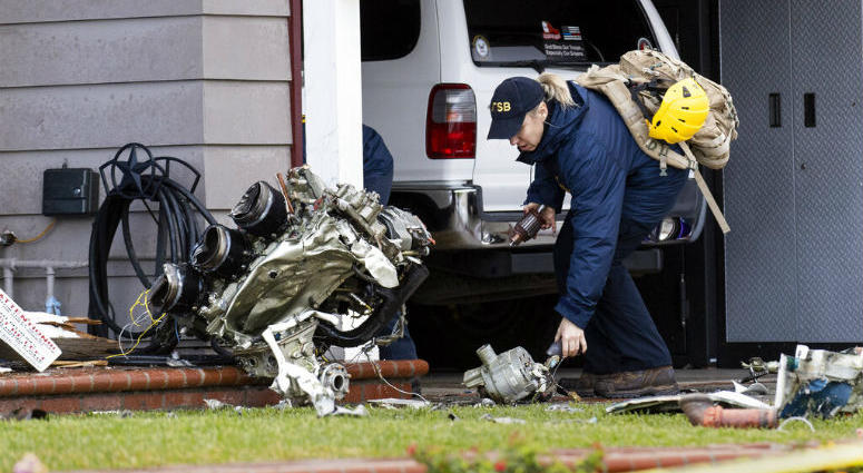 A National Transportation Safety Board worker takes a photo of an engine that came to rest against a house on Crestknoll Dr. in Yorba Linda, Calif on Monday, February 4, 2019. A National Transportation Safety Board worker takes a photo of an engine that came to rest against a house on Crestknoll Dr. in Yorba Linda, Calif on Monday, February 4, 2019.