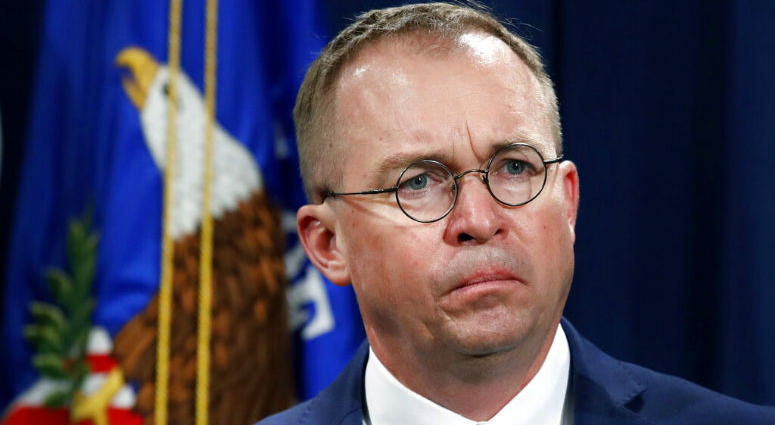 FILE- In this July 11, 2018, file photo Mick Mulvaney, acting director of the Consumer Financial Protection Bureau (CFPB), and Director of the Office of Management, listens during a news conference at the Department of Justice in Washington. FILE- In this July 11, 2018, file photo Mick Mulvaney, acting director of the Consumer Financial Protection Bureau (CFPB), and Director of the Office of Management, listens during a news conference at the Department of Justice in Washington.