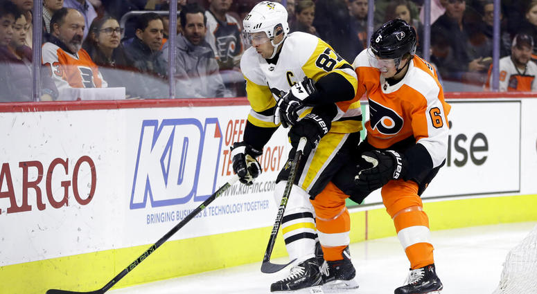 Pittsburgh Penguins' Sidney Crosby (87) and Philadelphia Flyers' Travis Sanheim (6) battle for the puck during the first period of an NHL hockey game, Monday, Feb. 11, 2019, in Philadelphia. Pittsburgh Penguins' Sidney Crosby (87) and Philadelphia Flyers' Travis Sanheim (6) battle for the puck during the first period of an NHL hockey game, Monday, Feb. 11, 2019, in Philadelphia.