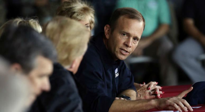 FILE - In this Sept. 19, 2018, file photo, President Donald Trump listens as FEMA Administrator Brock Long, right, speaks while attending a briefing, after arriving at Marine Corps Air Station Cherry Point to visit areas impacted by Hurricane Florence in FILE - In this Sept. 19, 2018, file photo, President Donald Trump listens as FEMA Administrator Brock Long, right, speaks while attending a briefing, after arriving at Marine Corps Air Station Cherry Point to visit areas impacted by Hurricane Florence in