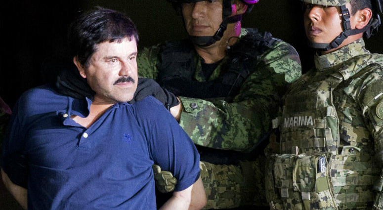FILE - In this Jan. 8, 2016 file photo, a handcuffed Joaquin "El Chapo" Guzman is made to face the press as he is escorted to a helicopter by Mexican soldiers and marines at a federal hangar in Mexico City. FILE - In this Jan. 8, 2016 file photo, a handcuffed Joaquin "El Chapo" Guzman is made to face the press as he is escorted to a helicopter by Mexican soldiers and marines at a federal hangar in Mexico City.