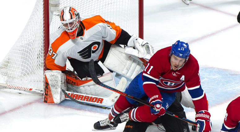 Montreal Canadiens' Brendan Gallagher falls over Philadelphia Flyers defenceman Robert Hagg in front of goaltender Brian Elliott during the third period of an NHL hockey game Thursday, Feb. 21, 2019, in Montreal. Flyers