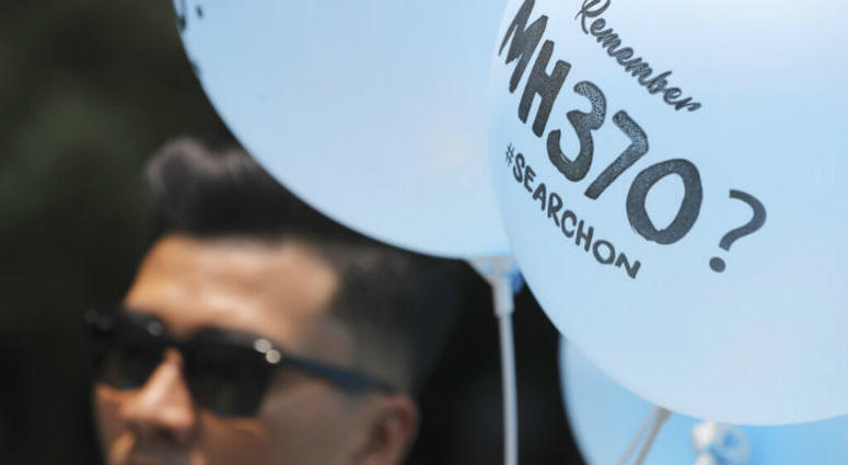 A volunteer gives out balloons printed with MH370 during a Day of Remembrance for MH370 event in Kuala Lumpur, Malaysia, Sunday, March 3, 2019. A volunteer gives out balloons printed with MH370 during a Day of Remembrance for MH370 event in Kuala Lumpur, Malaysia, Sunday, March 3, 2019.