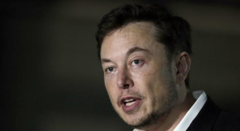 FILE - In this June 14, 2018, file photo, Tesla CEO Elon Musk speaks at a news conference in Chicago. FILE - In this June 14, 2018, file photo, Tesla CEO Elon Musk speaks at a news conference in Chicago.