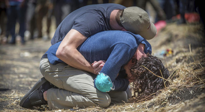 Relatives react at the scene where the Ethiopian Airlines Boeing 737 Max 8 crashed shortly after takeoff on Sunday killing all 157 on board, near Bishoftu, south of Addis Ababa, in Ethiopia Wednesday, March 13, 2019. Relatives react at the scene where the Ethiopian Airlines Boeing 737 Max 8 crashed.