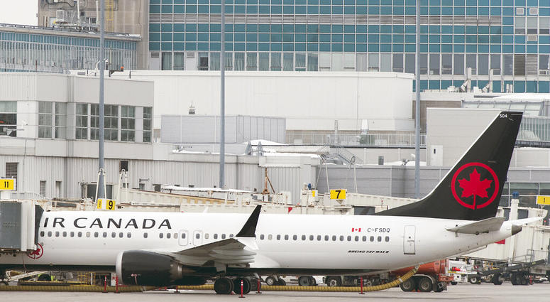 An Air Canada Boeing 737 Max 8 aircraft is parked next to a gate at Trudeau Airport in Montreal, Wednesday, March 13, 2019. An Air Canada Boeing 737 Max 8 aircraft