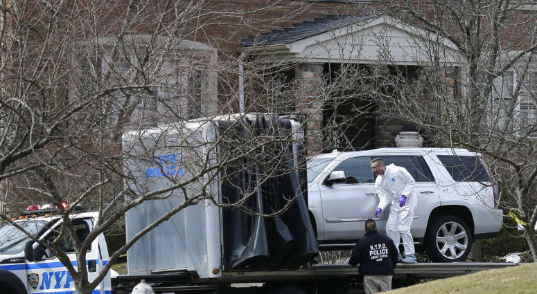 Crime scene investigators load a car that appears to have been checked for fingerprints onto a flatbed truck in the Staten Island borough of New York, Thursday, March 14, 2019. Crime scene investigators load a car that appears to have been checked for fingerprints onto a flatbed truck in the Staten Island borough of New York, Thursday, March 14, 2019.