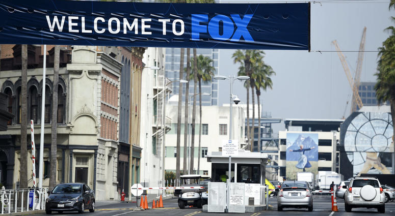 Cars enter and leave Fox Studios, Tuesday, March 19, 2019, in Los Angeles. Cars enter and leave Fox Studios.