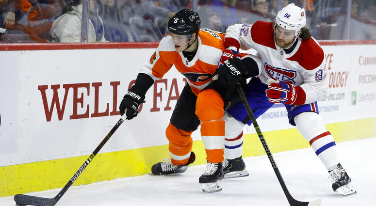 Philadelphia Flyers' Travis Sanheim, left, and Montreal Canadiens' Jonathan Drouin battle for the puck during the first period of an NHL hockey game, Tuesday, March 19, 2019, in Philadelphia. ( Philadelphia Flyers' Travis Sanheim, left, and Montreal Canadiens' Jonathan Drouin battle for the puck during the first period of an NHL hockey game.