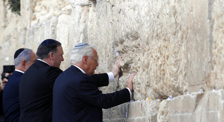 Israeli Prime Minister Benjamin Netanyahu, U.S. Secretary of State Mike Pompeo and U.S. Ambassador to Israel David Friedman touch the stones of the Western Wall during a visit to the site in Jerusalem's Old City, Thursday, March 21, 2019. Israeli Prime Minister Benjamin Netanyahu, U.S. Secretary of State Mike Pompeo and U.S. Ambassador to Israel David Friedman