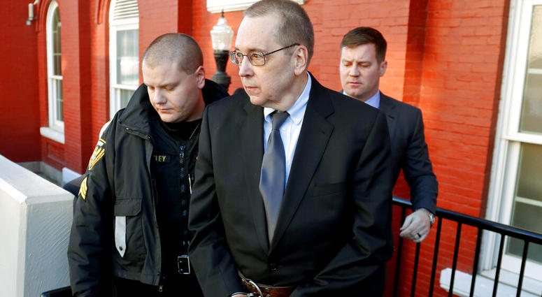 In this Jan. 11, 2019 file photo, David Poulson, center, a Roman Catholic priest who pleaded guilty to sexually abusing two boys, is taken away from court after sentencing in Brookville, Pa. David Poulson, center, a Roman Catholic priest who pleaded guilty to sexually abusing two boys.
