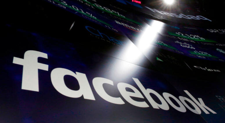 FILE- In this March 29, 2018, file photo, the logo for Facebook appears on screens at the Nasdaq MarketSite in New York's Times Square. Facebook is facing housing discrimination charges from the U.S. Department of Housing and Urban Development. Facebook is facing housing discrimination charges from the U.S. Department of Housing and Urban Development.