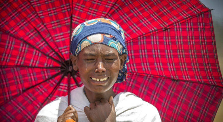 FILE - In this Wednesday March 13, 2019 file photo, a family member reacts at the scene where the Ethiopian Airlines jet crashed near Bishoftu, in Ethiopia, just after taking off from Addis Ababa on March 10, killing all 157 on board. A preliminary report finds that the crew of the Ethiopian Airlines jet that crashed last month performed all the procedures recommended by Boeing but could not control the plane.