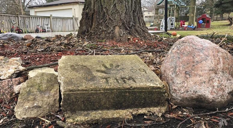 A slab of concrete sits in the backyard of the house where Timmothy Pitzen used to live in Aurora, Illinois, Thursday, April, 2019. Authorities conducted DNA testing to try to determine Thursday whether a teenager found wandering the streets of a Kentucky town is who he claims to be — an Illinois boy who disappeared eight years ago around the time his mother took her own life.