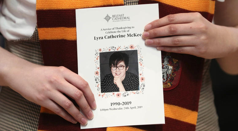 A mourner wearing a Harry Potter Gryffindor House scarf holds an order of service as she arrives for the funeral of slain journalist Lyra McKee at St Anne's Cathedral in Belfast, Northern Ireland, Wednesday April 24, 2019. Lyra McKee funeral